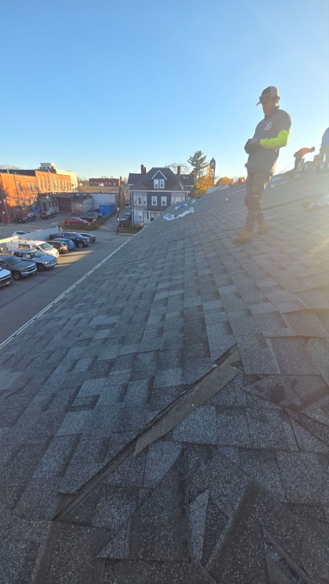 Roofing crew working on the sloped shingle roof at 50–58 Walnut Street in Waltham